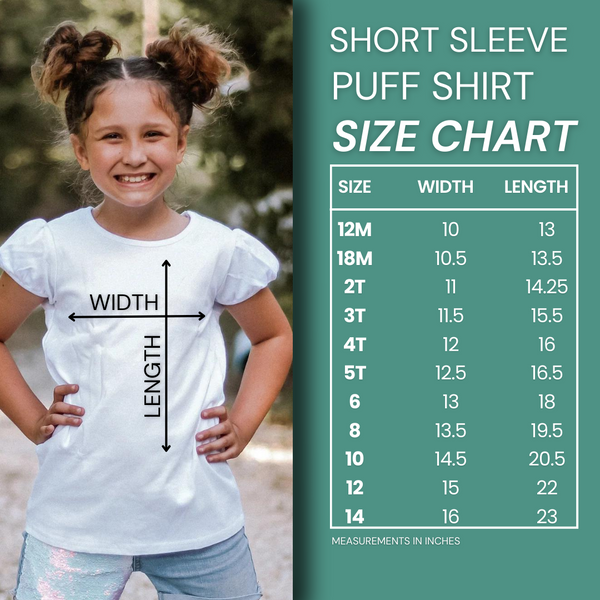 a little girl wearing a white shirt with a size chart